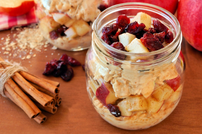 Jar with overnight oats with apples and cranberries