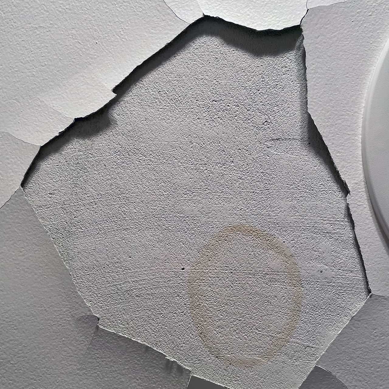 [Photo: A *bigger* stain in our bathroom ceiling]